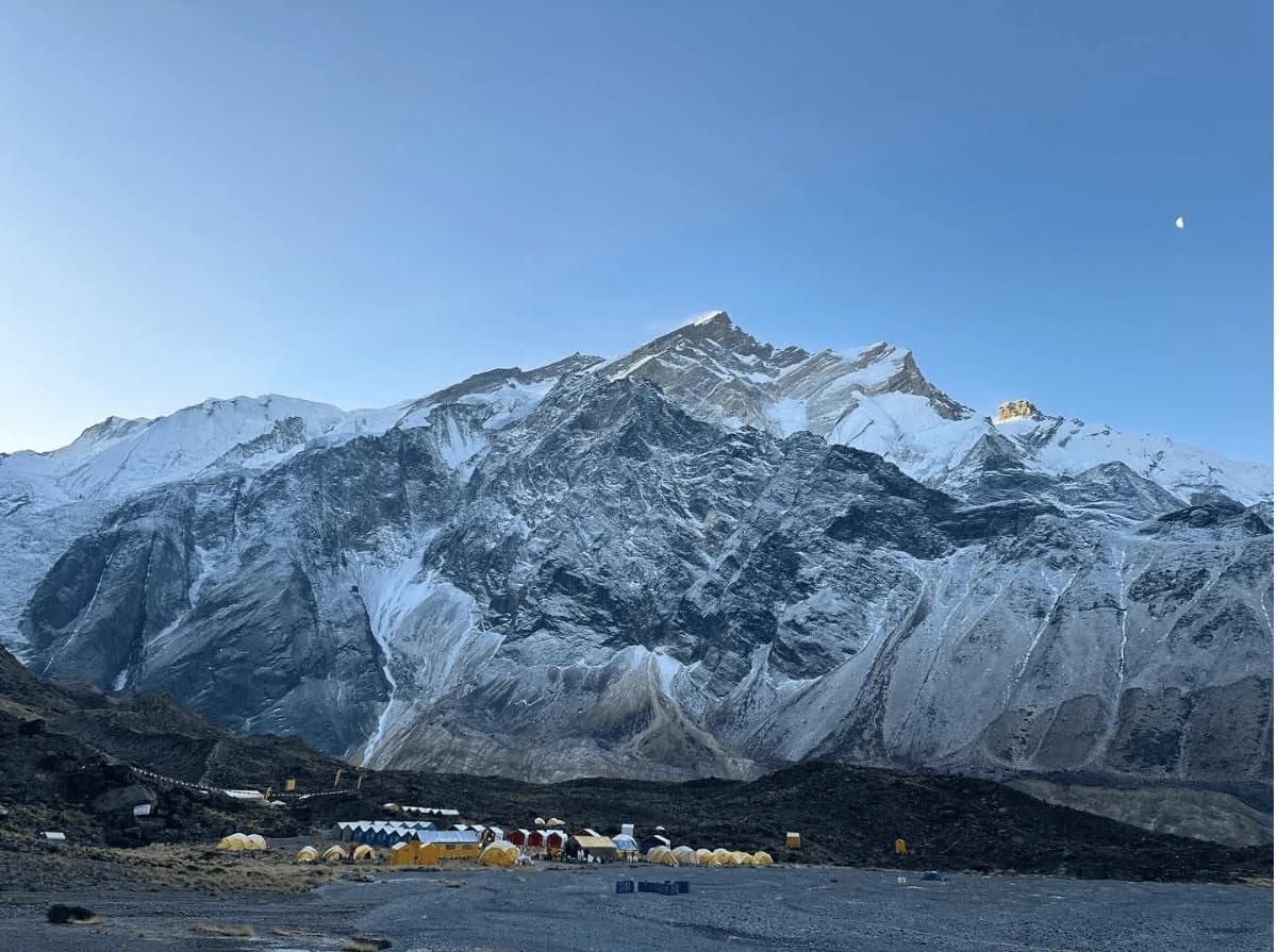 Colorful expedition tents at Everest Base Camp beneath the towering Khumbu Icefall and Mount Everest during the spring climbing season in Nepal.