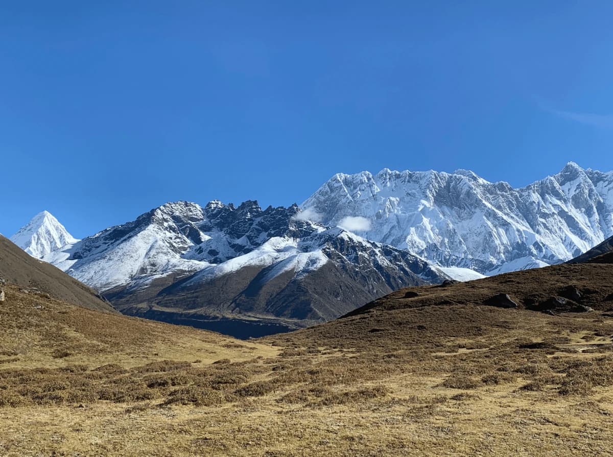 Panoramic view of the Everest mountain range, including Mount Everest, Lhotse, Ama Dablam, and surrounding Himalayan peaks, seen from Pangboche village during the Everest Base Camp Trek.