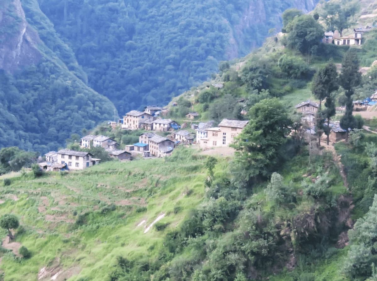 Traditional mountain village along the Api Himal Base Camp Trek in Far West Nepal surrounded by green hills and Himalayan landscapes