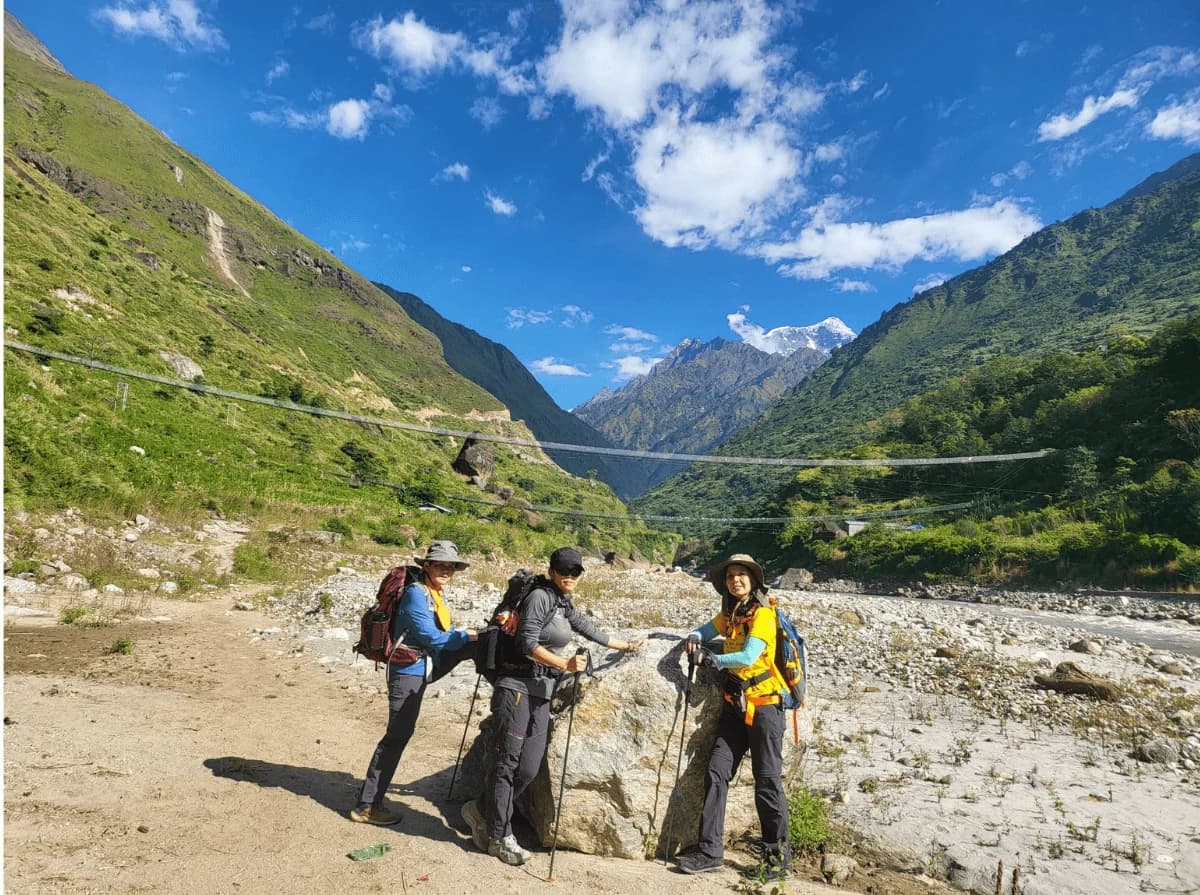 trekkers on riverside manaslu