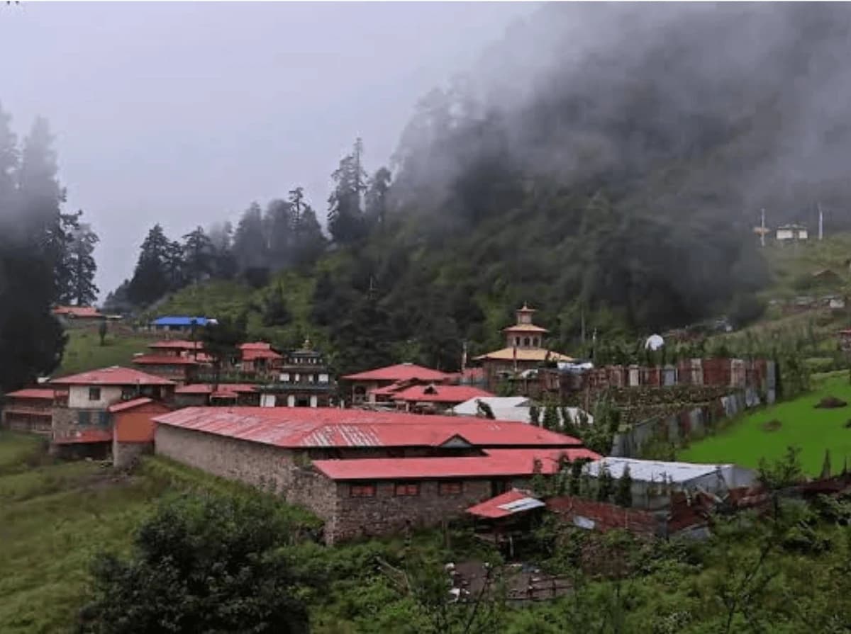 Serang Gompa village surrounded by green hills and forests on the Manaslu Circuit Trek