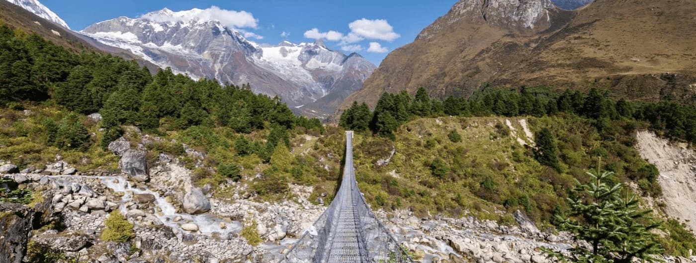 Scenic Manaslu Circuit Trek route along the river valley beneath the Himalayan mountains in Nepal